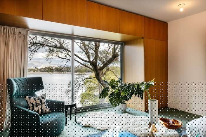 Fleetwood walls of glass with lake view and black chair and